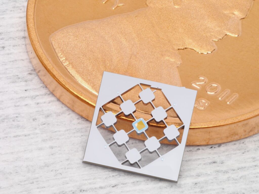The silicon nitride membrane that we use to transduce signals (a square about half a millimeter wide) is supported on a silicon chip about 6 millimeters wide. This chip is etched into a periodic array of pads joined by skinny tethers to isolate the membrane from its thermal environment.
