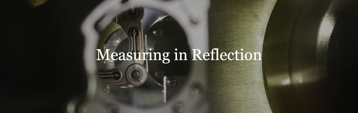 Measuring in Reflection blog banner image: a mirror in a physics lab reflecting another mirror and some other bits of scientific apparatus