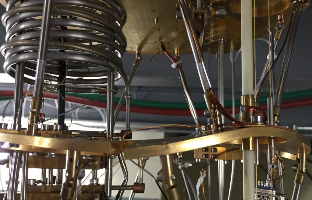 The cryostat consists of a series of progressively colder gold plates  stacked vertically and connected by lots of pipes and tubes. These plates are warped in an alarming way.